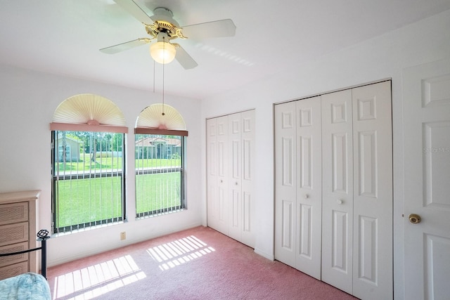 13 Point Of Woods Dr, Palm Coast, FL 32164 - unfurnished bedroom featuring two closets, carpet, and ceiling fan
