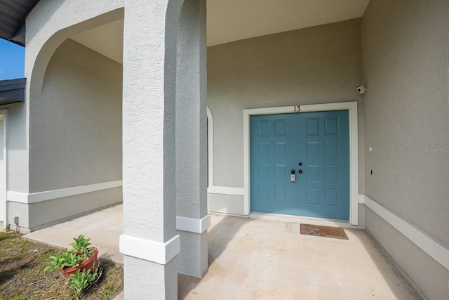 13 Point Of Woods Dr, Palm Coast, FL 32164 - view of exterior entry featuring stucco siding