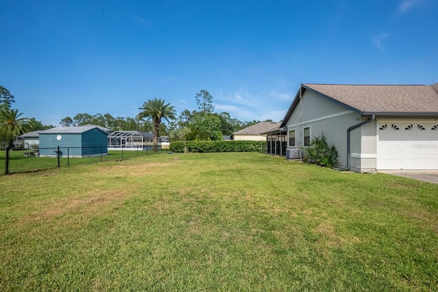 13 Point Of Woods Dr, Palm Coast, FL 32164 - view of yard with an attached garage and central AC unit