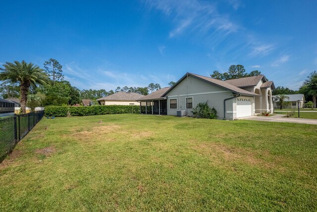 13 Point Of Woods Dr, Palm Coast, FL 32164 - view of yard with a garage and driveway
