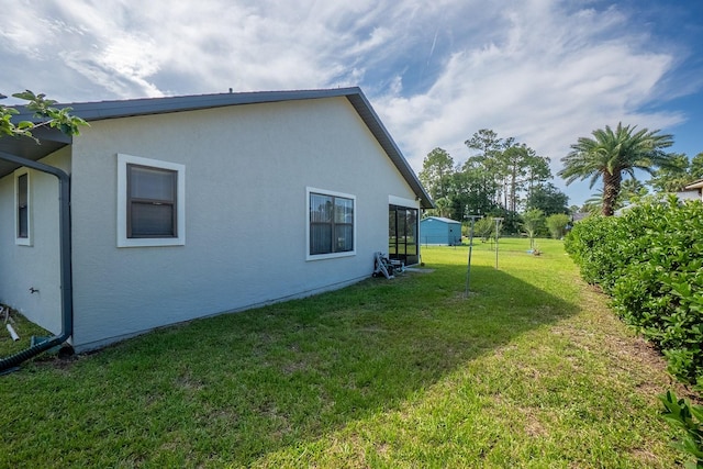 13 Point Of Woods Dr, Palm Coast, FL 32164 - rear view of house with stucco siding and a lawn