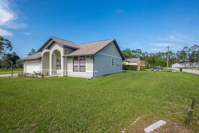 13 Point Of Woods Dr, Palm Coast, FL 32164 - view of home's exterior featuring a garage, stucco siding, a yard, concrete driveway, and a shingled roof
