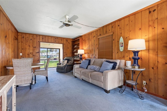 168 Palmetto Ave, Flagler Beach, FL 32136 - carpeted living area featuring wood walls, ceiling fan, and ornamental molding