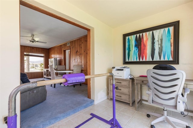 168 Palmetto Ave, Flagler Beach, FL 32136 - office area with wood walls, a ceiling fan, light tile patterned floors, light carpet, and baseboards