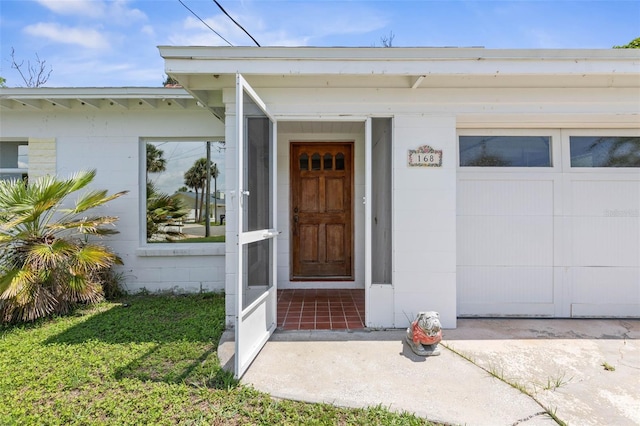 168 Palmetto Ave, Flagler Beach, FL 32136 - doorway to property featuring concrete block siding and a garage