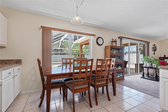 18 Royal Palm Ln, Palm Coast, FL 32164 - dining area featuring a textured ceiling, light tile patterned floors, and light carpet