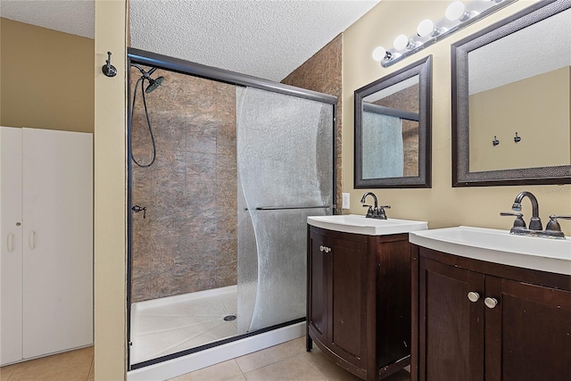 18 Royal Palm Ln, Palm Coast, FL 32164 - full bathroom featuring a shower stall, a textured ceiling, two vanities, and tile patterned flooring