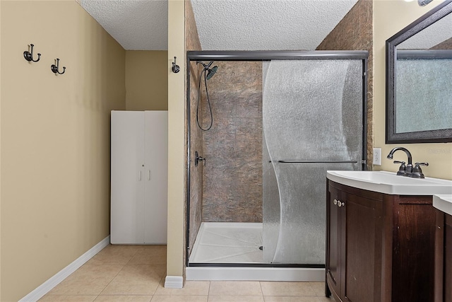 18 Royal Palm Ln, Palm Coast, FL 32164 - full bath with vanity, a stall shower, tile patterned floors, a textured ceiling, and baseboards
