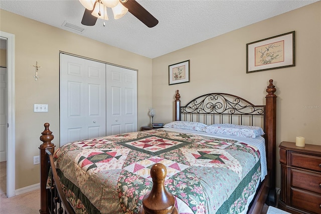 18 Royal Palm Ln, Palm Coast, FL 32164 - carpeted bedroom featuring a closet, a ceiling fan, and a textured ceiling