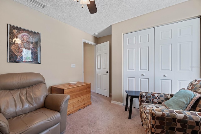 18 Royal Palm Ln, Palm Coast, FL 32164 - living area with light colored carpet, a ceiling fan, a textured ceiling, and baseboards