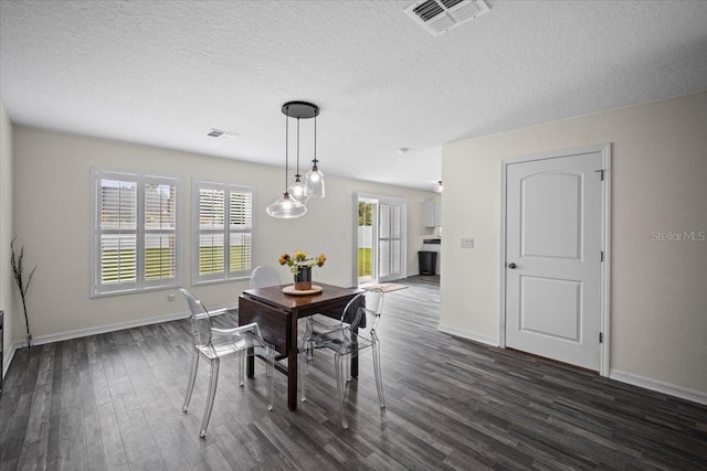 6 Ryding Ln, Palm Coast, FL 32164 - dining area with dark wood-style floors, baseboards, and a textured ceiling