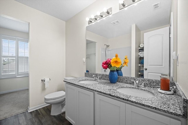 6 Ryding Ln, Palm Coast, FL 32164 - full bath with wood finished floors, double vanity, toilet, and baseboards