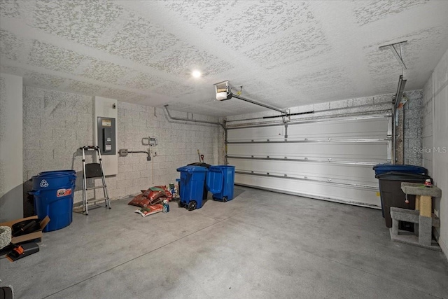 6 Ryding Ln, Palm Coast, FL 32164 - garage with electric panel, concrete block wall, and a garage door opener