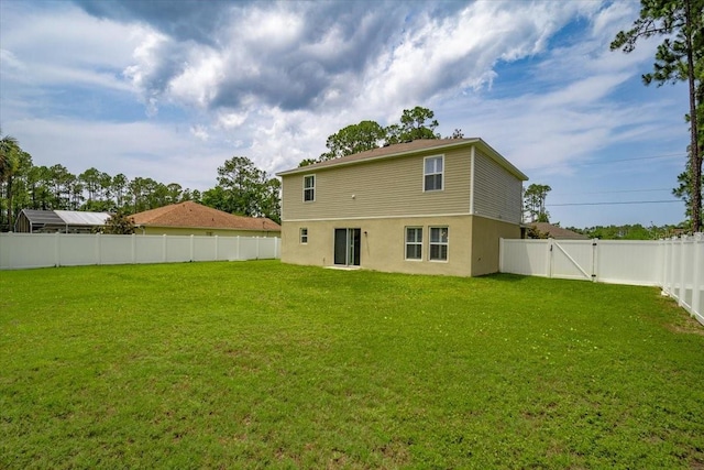 6 Ryding Ln, Palm Coast, FL 32164 - back of house with stucco siding and a gate
