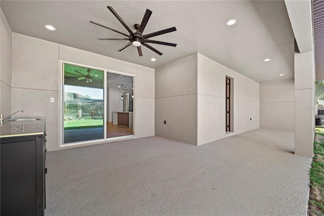 11 Ethan Allen Dr, Palm Coast, FL 32164 - unfurnished living room with carpet floors, a ceiling fan, recessed lighting, and a textured ceiling