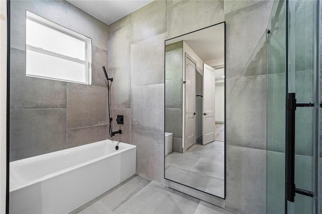 11 Ethan Allen Dr, Palm Coast, FL 32164 - full bathroom with tile walls, marble look tile flooring, and  shower combination