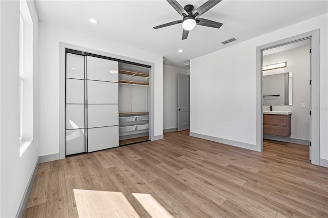 11 Ethan Allen Dr, Palm Coast, FL 32164 - unfurnished bedroom with light wood finished floors, a closet, recessed lighting, ensuite bath, and ceiling fan