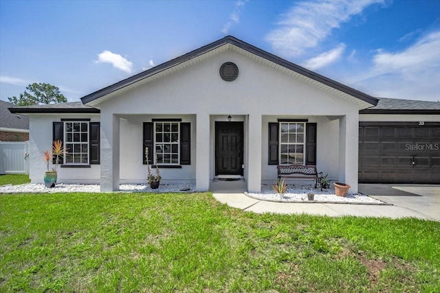 33 Bud Field Dr, Palm Coast, FL 32137 - view of front of house featuring an attached garage, a front yard, stucco siding, and driveway