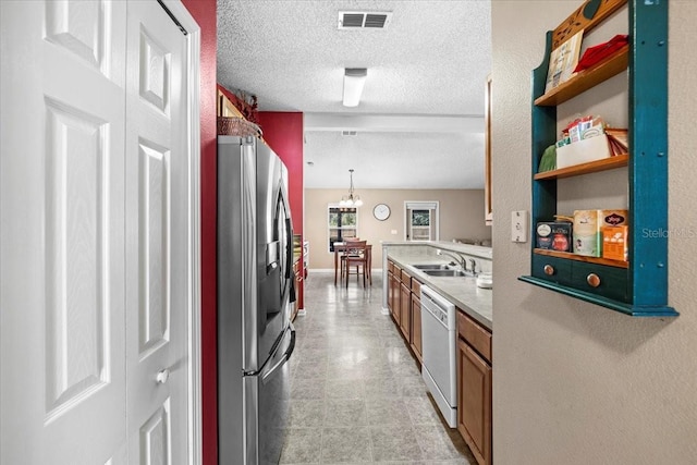 33 Bud Field Dr, Palm Coast, FL 32137 - kitchen with stainless steel refrigerator with ice dispenser, dishwasher, a sink, brown cabinetry, and open shelves