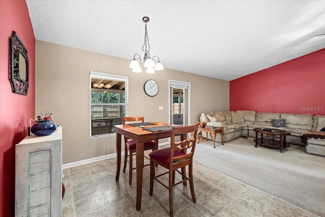 33 Bud Field Dr, Palm Coast, FL 32137 - dining space featuring a textured ceiling, a chandelier, and baseboards