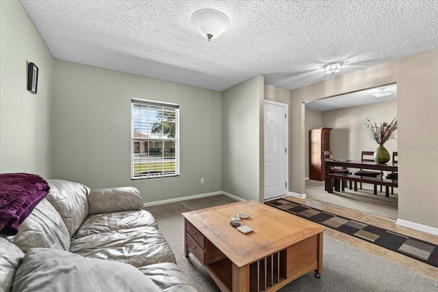 33 Bud Field Dr, Palm Coast, FL 32137 - living area featuring a textured ceiling, baseboards, and carpet floors