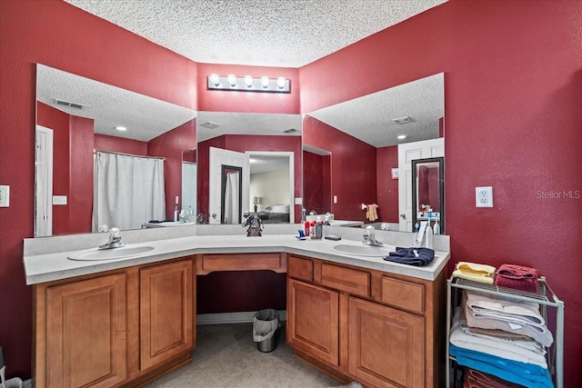 33 Bud Field Dr, Palm Coast, FL 32137 - bathroom featuring a textured ceiling, double vanity, a textured wall, tile patterned floors, and a shower with shower curtain