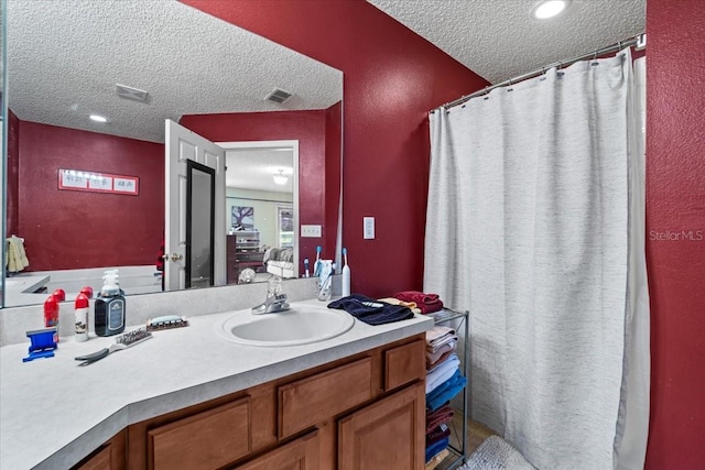 33 Bud Field Dr, Palm Coast, FL 32137 - full bathroom featuring a textured ceiling, vanity, a shower with shower curtain, and a textured wall