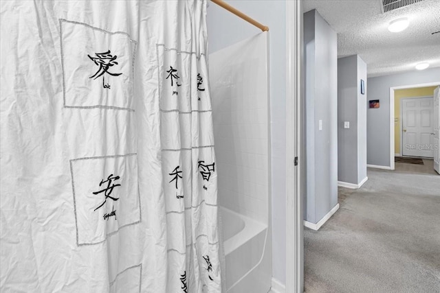 33 Bud Field Dr, Palm Coast, FL 32137 - full bath featuring a textured ceiling, baseboards, and shower / bathtub combination with curtain