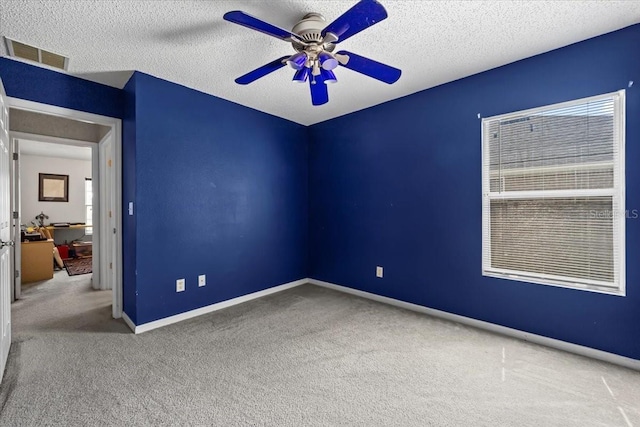 33 Bud Field Dr, Palm Coast, FL 32137 - carpeted empty room featuring a ceiling fan, baseboards, and a textured ceiling