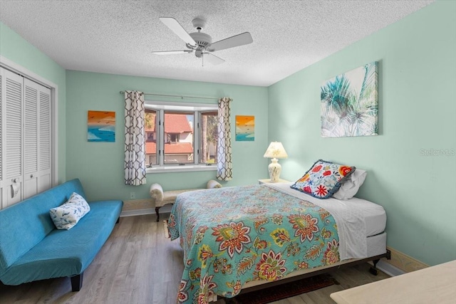 2934 Oceans Trce, Daytona Beach Shores, FL 32118 - bedroom with a closet, wood finished floors, a ceiling fan, and a textured ceiling