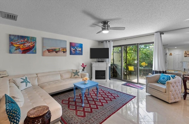 2934 Oceans Trce, Daytona Beach Shores, FL 32118 - living area with ceiling fan, a fireplace, and a textured ceiling