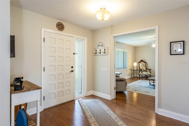 40 Cloverdale Ct N, Palm Coast, FL 32137 - entrance foyer with dark wood-type flooring, baseboards, a ceiling fan, and a textured ceiling
