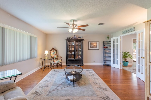 40 Cloverdale Ct N, Palm Coast, FL 32137 - living area with french doors, a ceiling fan, wood finished floors, and baseboards