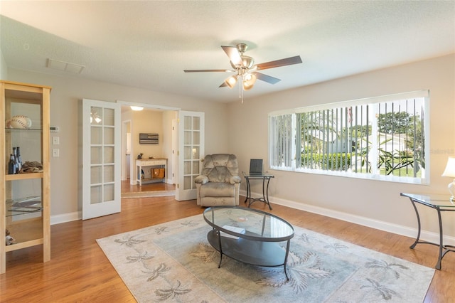 40 Cloverdale Ct N, Palm Coast, FL 32137 - sitting room featuring french doors, wood finished floors, a ceiling fan, and baseboards