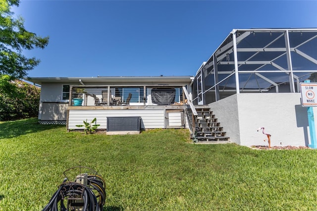40 Cloverdale Ct N, Palm Coast, FL 32137 - rear view of property with stairs, a lawn, a lanai, and stucco siding