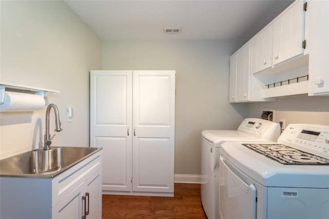 40 Cloverdale Ct N, Palm Coast, FL 32137 - washroom featuring independent washer and dryer, dark wood-type flooring, cabinet space, and baseboards
