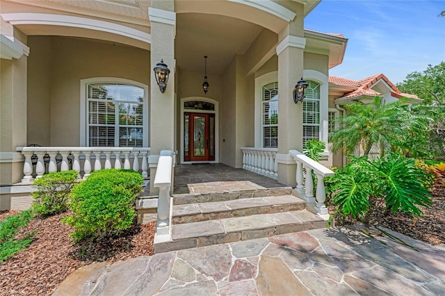 129 Front St, Palm Coast, FL 32137 - view of exterior entry featuring covered porch and stucco siding