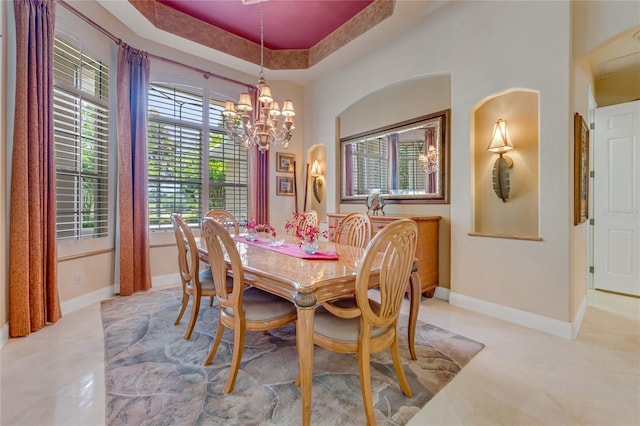 129 Front St, Palm Coast, FL 32137 - dining space featuring baseboards, a chandelier, and a raised ceiling