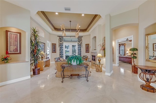 129 Front St, Palm Coast, FL 32137 - living room featuring a raised ceiling, light marble finish floors, a ceiling fan, baseboards, and recessed lighting