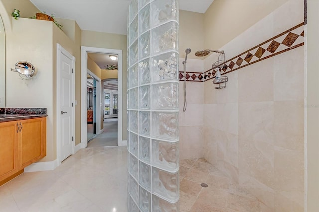 129 Front St, Palm Coast, FL 32137 - full bathroom with a walk in shower, vanity, connected bathroom, and tile patterned flooring