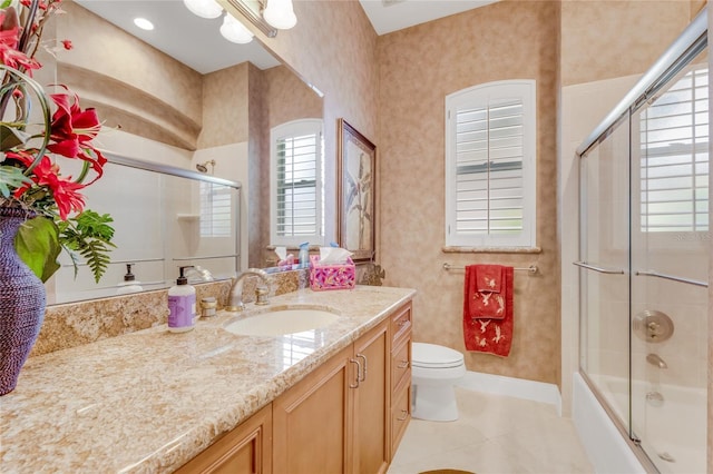 129 Front St, Palm Coast, FL 32137 - full bath featuring vanity, tile patterned flooring, toilet, and shower / bath combination with glass door