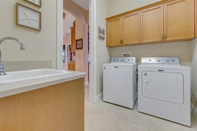 129 Front St, Palm Coast, FL 32137 - laundry room featuring cabinet space, arched walkways, and washer and clothes dryer