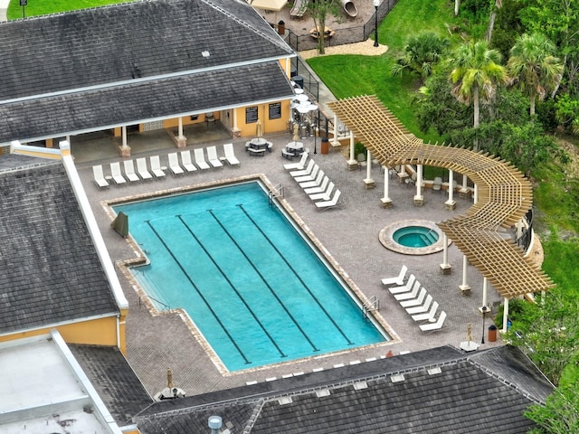 129 Front St, Palm Coast, FL 32137 - community pool featuring a patio area, a community hot tub, a pergola, an outbuilding, and a storage structure