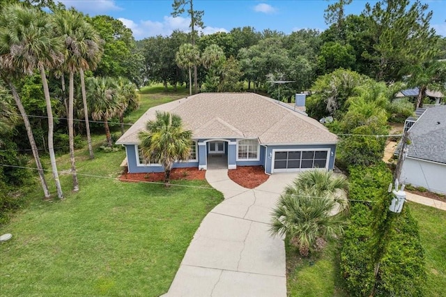49 Ludlow Ln W, Palm Coast, FL 32137 - view of front facade featuring a garage, concrete driveway, a front lawn, and french doors