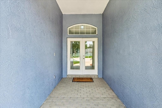 49 Ludlow Ln W, Palm Coast, FL 32137 - doorway to property featuring stucco siding and french doors