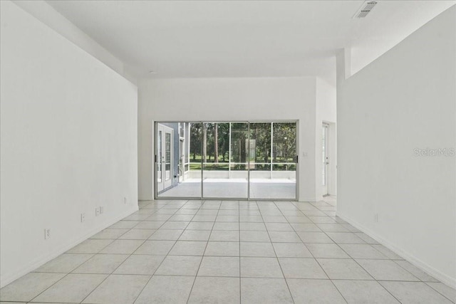 49 Ludlow Ln W, Palm Coast, FL 32137 - spare room with light tile patterned flooring and baseboards