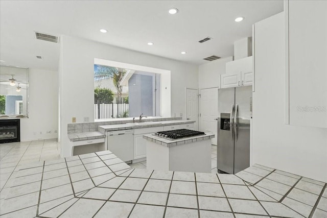 49 Ludlow Ln W, Palm Coast, FL 32137 - kitchen with stainless steel appliances, a sink, healthy amount of natural light, white cabinetry, and recessed lighting