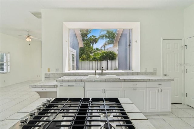 49 Ludlow Ln W, Palm Coast, FL 32137 - kitchen featuring tile countertops, white dishwasher, a sink, stainless steel gas cooktop, and light tile patterned flooring