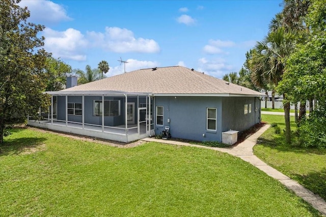 49 Ludlow Ln W, Palm Coast, FL 32137 - back of house with a sunroom, a yard, stucco siding, and a shingled roof