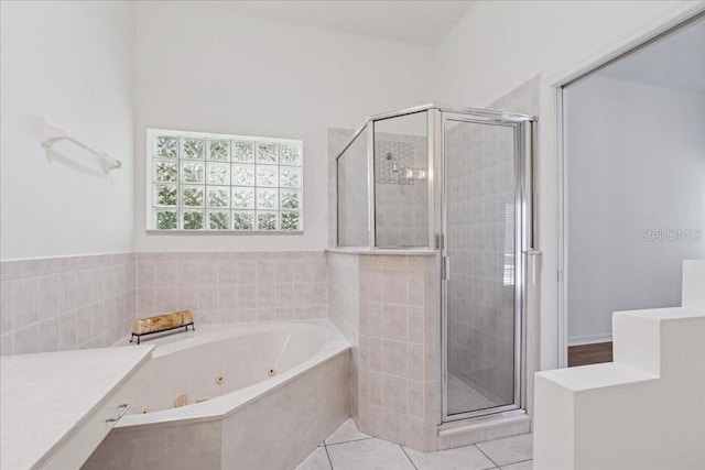 49 Ludlow Ln W, Palm Coast, FL 32137 - bathroom featuring a stall shower, a jetted tub, and tile patterned floors